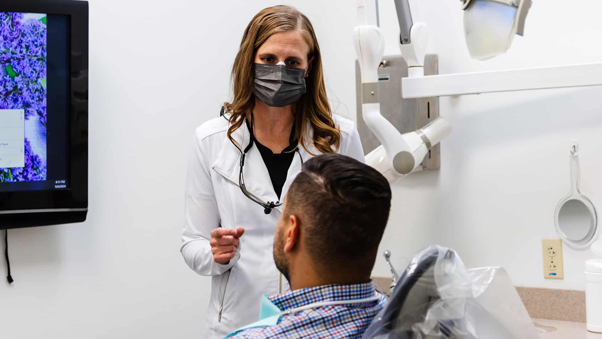 Dentist at Polished Explaining Root Canal Procedure